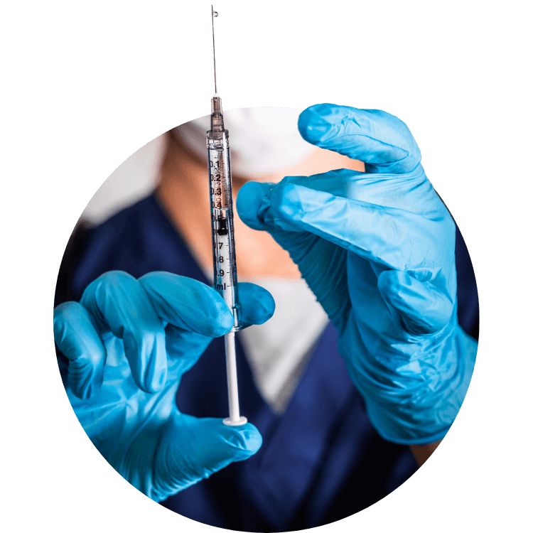 A doctor with gloved hands holding a hypodermic needle